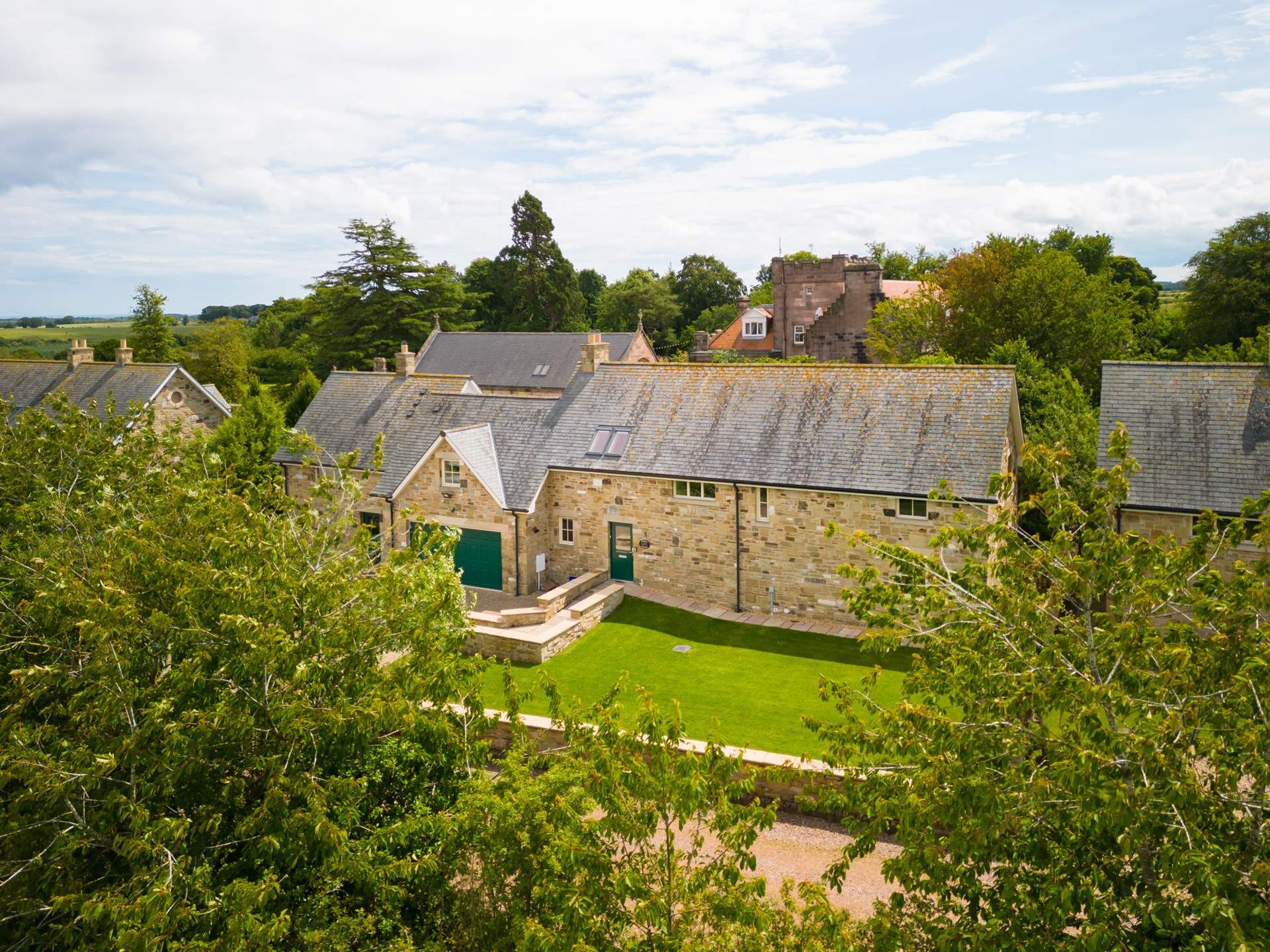 Keepers Cottage is nestled in the beautiful green countryside with Ellingham Hall, a popular wedding venue, in the background.