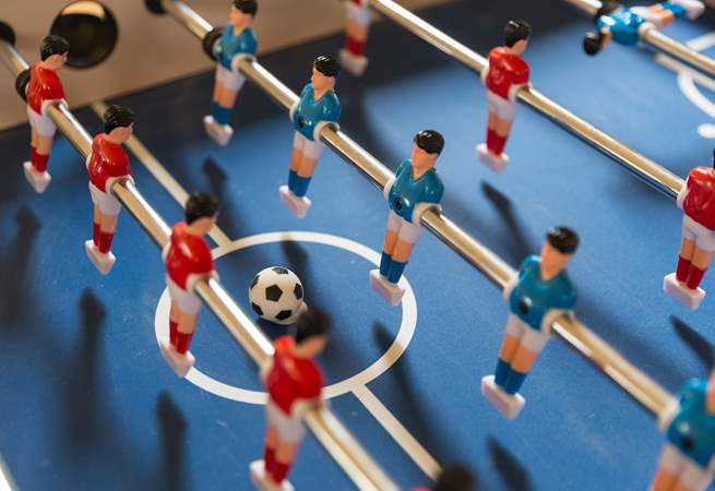 Challenge each other to a table football tournament.