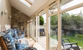 The light floods into the sun-room through the French doors. - Thumbnail Image