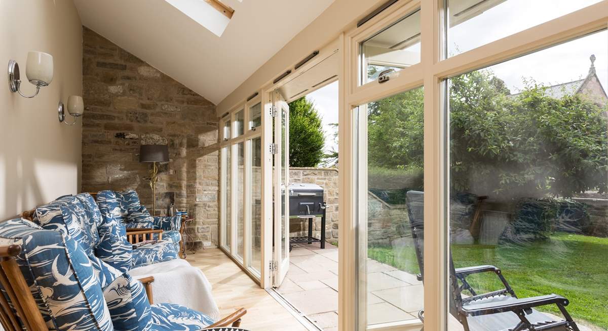 The light floods into the sun-room through the French doors.