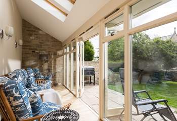 The light floods into the sun-room through the French doors.