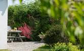 The sheltered area at the back of the garden is the perfect spot for morning coffee. - Thumbnail Image