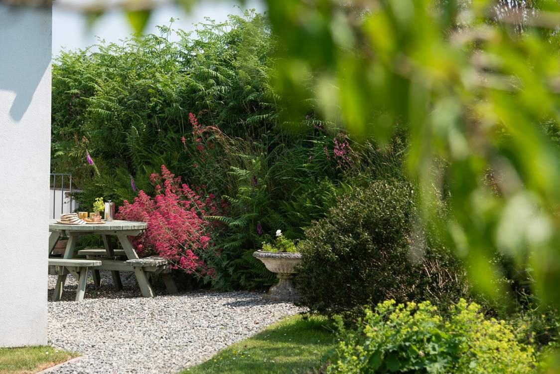 The sheltered area at the back of the garden is the perfect spot for morning coffee.