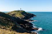 Strumble Head Lighthouse sitting on the dramatic Pembrokeshire coastline. 