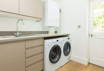 The handy utility-room has a washing machine and a tumble-drier. 