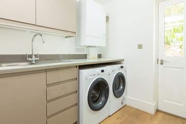 The handy utility-room has a washing machine and a tumble-drier.