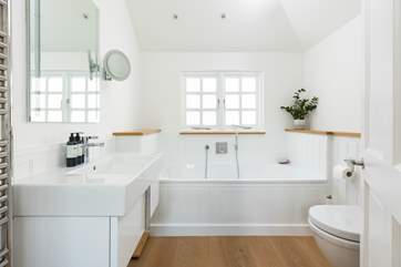 The lovely family bathroom has a bath and separate shower cubicle.