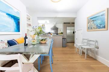 The dining-table sits in between the kitchen and sitting area, perfect for sociable dining.