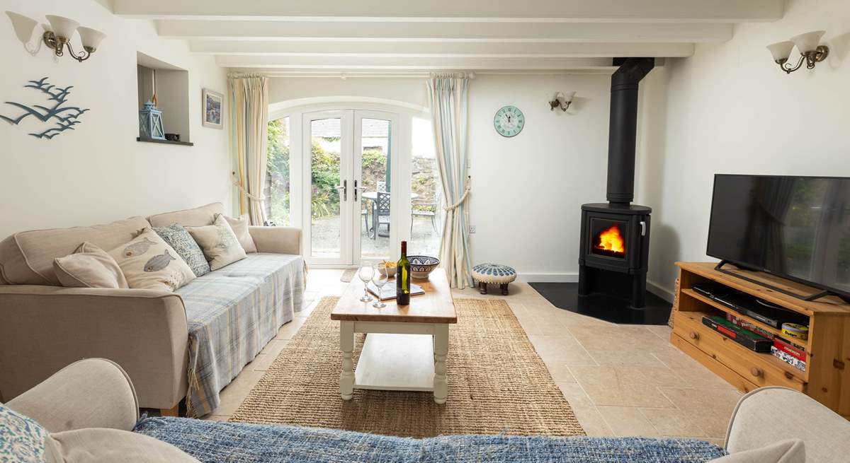 Big comfy sofas complete with log-burner to keep you cosy. The French doors open up to your private patio. 