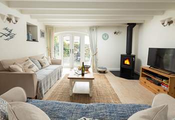 Big comfy sofas complete with log-burner to keep you cosy. The French doors open up to your private patio. 
