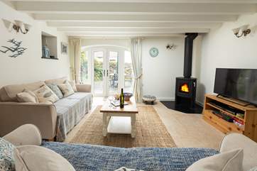 Big comfy sofas complete with log-burner to keep you cosy. The French doors open up to your private patio.