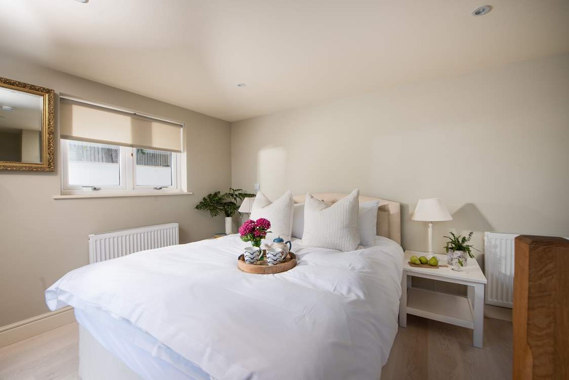 Calm colours in bedroom four, this king-size room is located at the rear of the house.