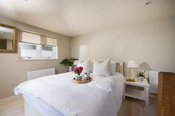 Calm colours in bedroom four, this king-size room is located at the rear of the house.