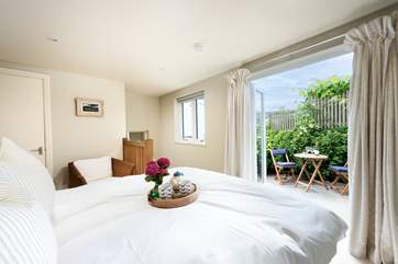 The king-size bedroom at the rear of the house is accessed via stairs from the utility-room and has direct access to its own rear terrace.