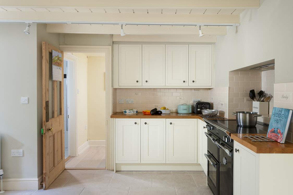 The L-shaped kitchen is at the rear of the house.