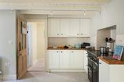 The L-shaped kitchen is at the rear of the house.