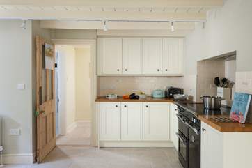 The L-shaped kitchen is at the rear of the house.