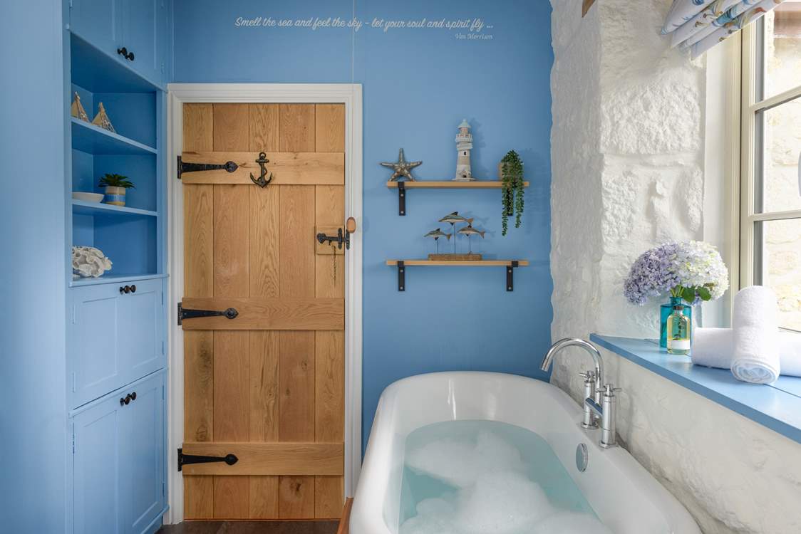 The rather lovely family bathroom has a free-standing bathtub.