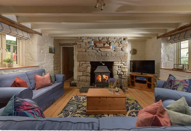 Relax around the flickering wood-burner, perfect for socialising and relaxing after busy day out exploring the coastal paths. 