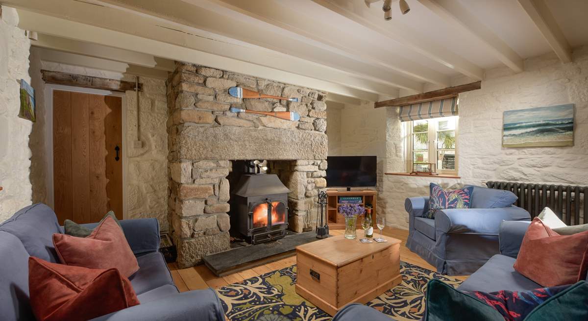 At one end you'll discover two sofas and an armchair nestled around the flickering wood-burner, perfect for socialising and relaxing after a busy day out exploring the coastal paths. 