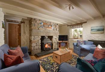At one end you'll discover two sofas and an armchair nestled around the flickering wood-burner, perfect for socialising and relaxing after a busy day out exploring the coastal paths. 