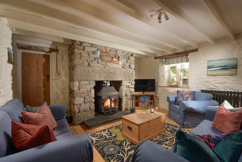 At one end you'll discover two sofas and an armchair nestled around the flickering wood-burner, perfect for socialising and relaxing after a busy day out exploring the coastal paths. 