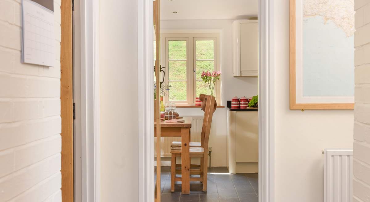 There is a handy cloakroom next to the kitchen. You can see the door slightly ajar (to the left).