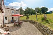 The lovely sun terrace is perfect for outdoor living. Please take care with children on the sloped areas.