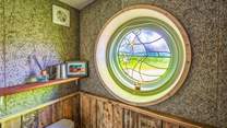 This beautiful stained glass window depicts the winding path through Powdermill Wood towards Battle. 