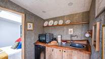 The rustic, wooden kitchen is well-equipped with all the essentials. 