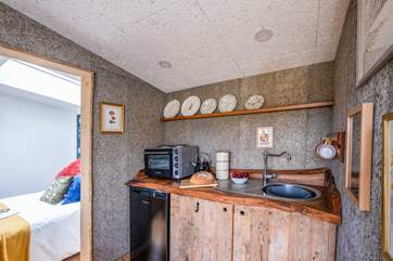 The rustic, wooden kitchen is well-equipped with all the essentials.