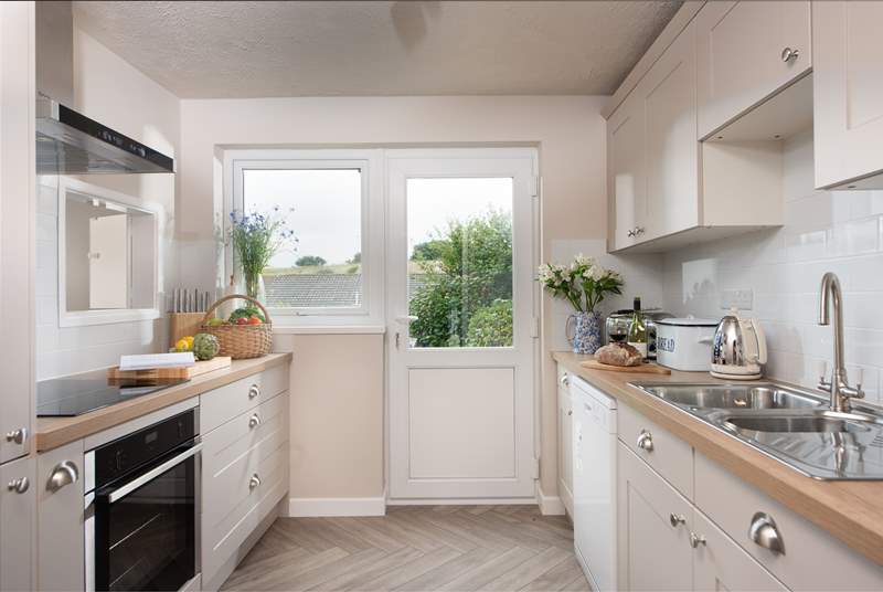 The stylish kitchen is decorated in soft colours for a calm cooking experience.