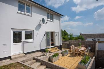 The outside terrace, perfect for dining with friends. Steps lead down to the parking area at the rear of the garage.