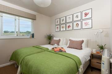 Beautiful bedroom two with three-foot single beds.