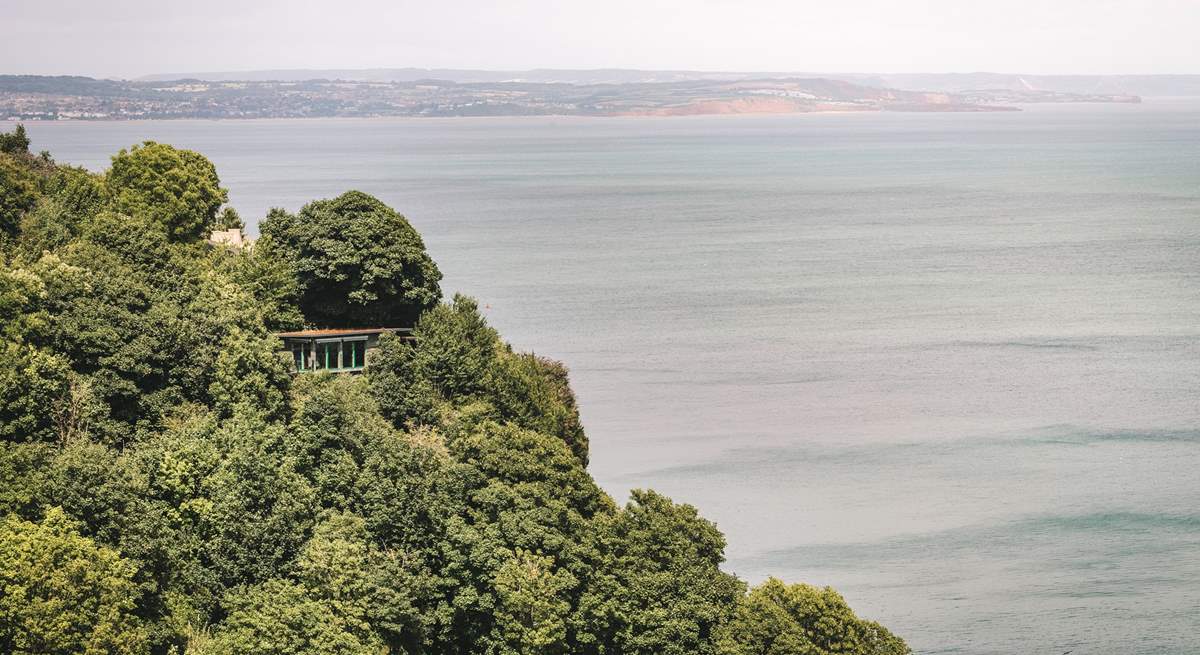 Welcome to The Nest, snuggled on a cliffside with spellbinding views over verdant trees and the glistening ocean.