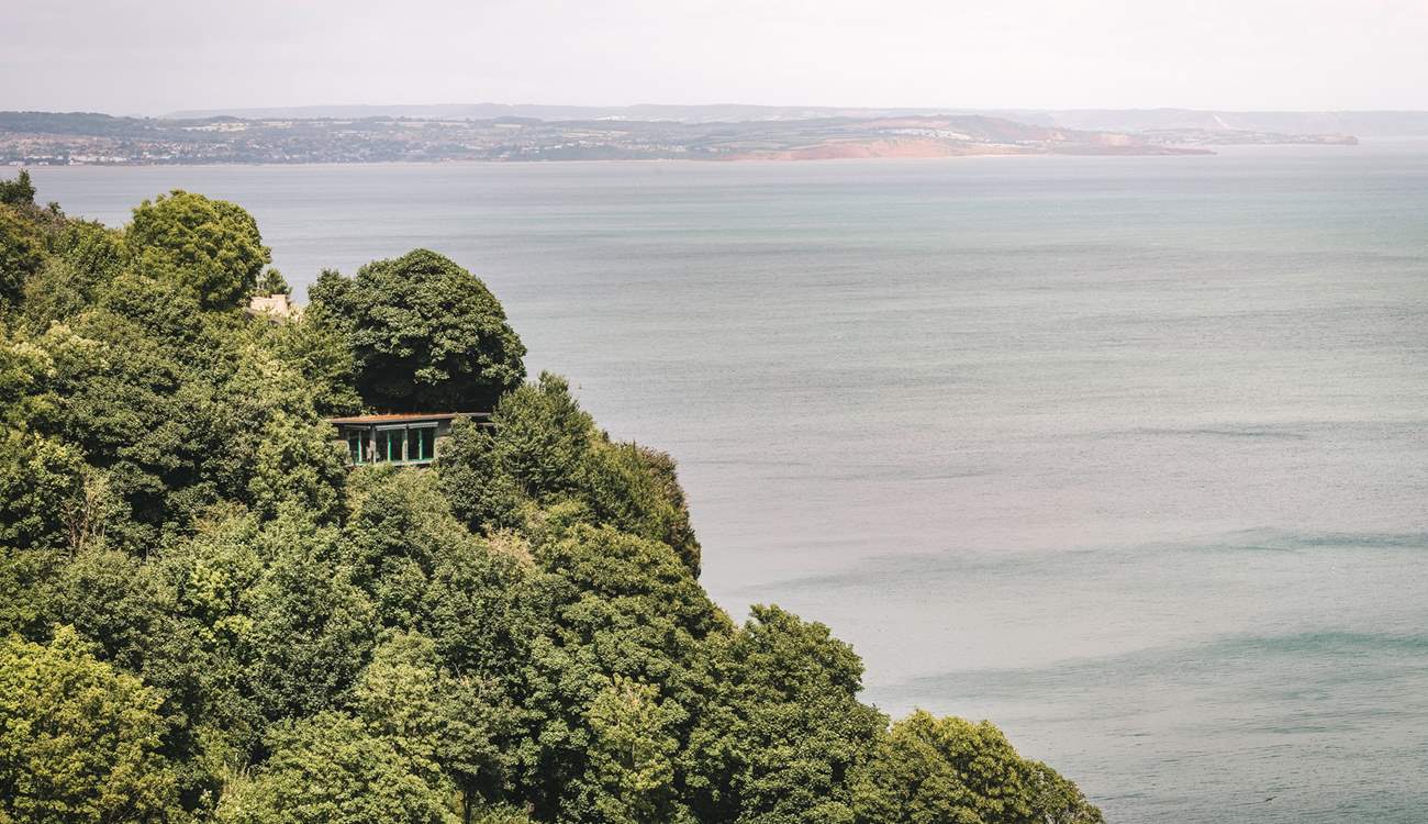 Welcome to The Nest, snuggled on a cliffside with spellbinding views over verdant trees and the glistening ocean.
