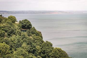Welcome to The Nest, snuggled on a cliffside with spellbinding views over verdant trees and the glistening ocean.
