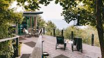 Wander through the trees and arrive at your romantic clifftop cabin.