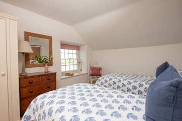 Twin beds await in the fourth bedroom.