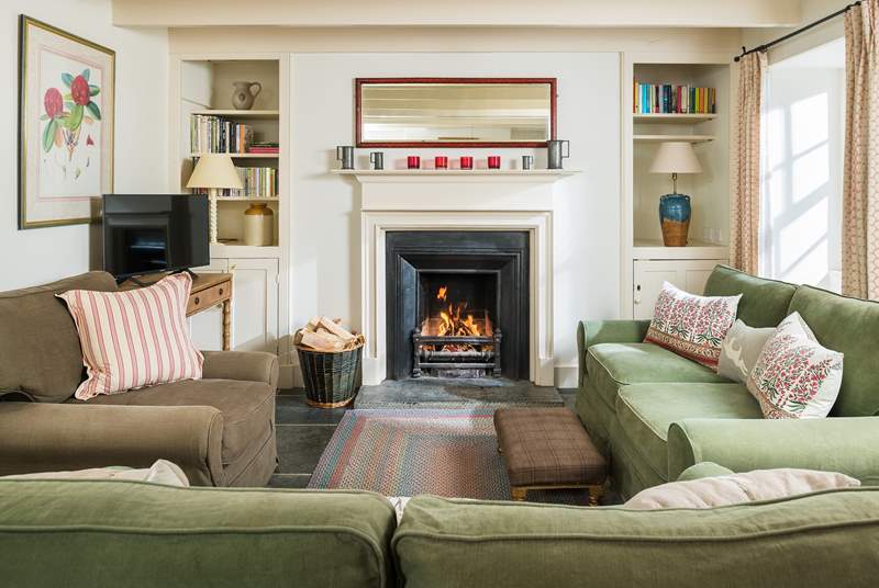 The cosy sitting/dining-room is warmed by an open fire. 