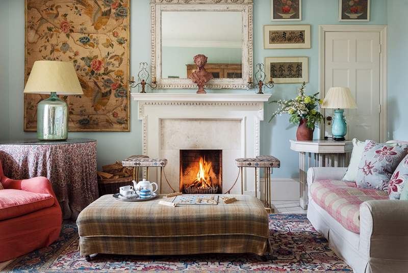 The large fireplace is the focal point of the room with the open fire for those out-of-season breaks.
