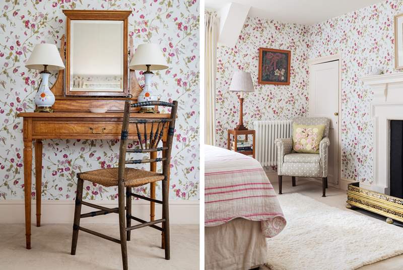A beautiful room decorated in pretty sweet-pea wallpaper.