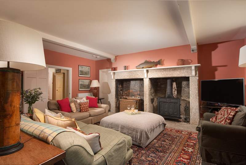 The large fireplace is the focal point of the room with the all important wood-burning stove for those out-of-season breaks.