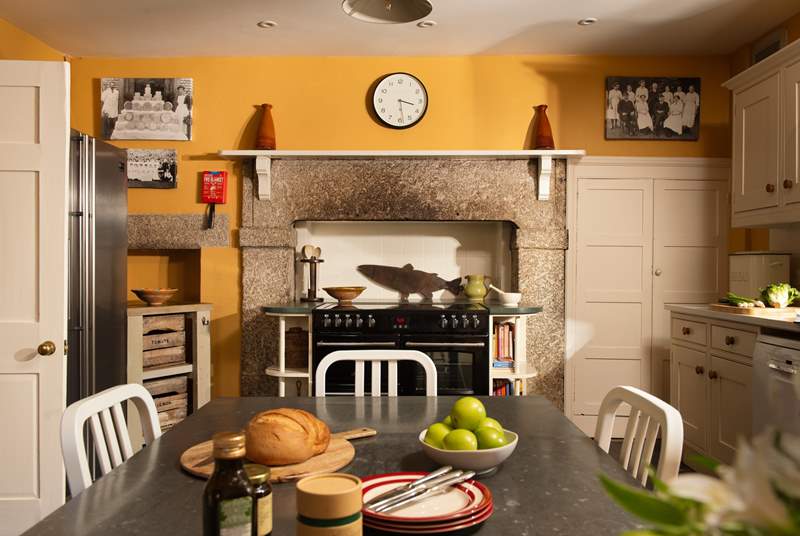 The range-style cooker is perfectly framed by the original granite surround.
