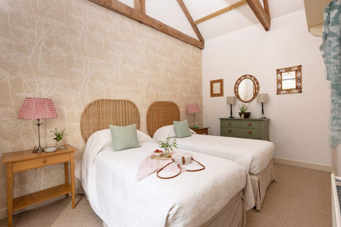 Two charming bedrooms await at this lovely courtyard cottage.
