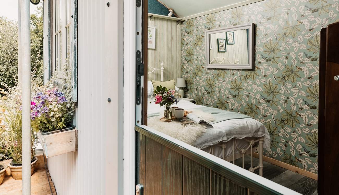 Open the stable-door to the shepherd's hut to find your beautiful sleeping area. 