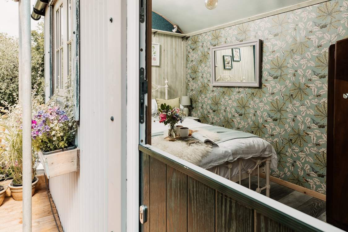 Open the stable-door to the shepherd's hut to find your beautiful sleeping area.