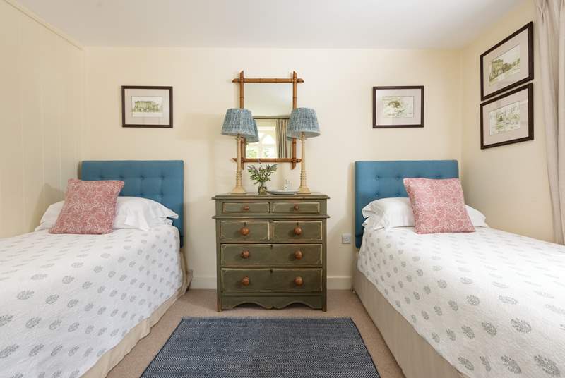 The twin bedded room, where the beds are adorned with plump cushions and lovely bedspreads.