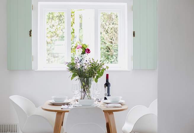 The dining space is tucked away at the front of the cottage overlooking the garden across the path.