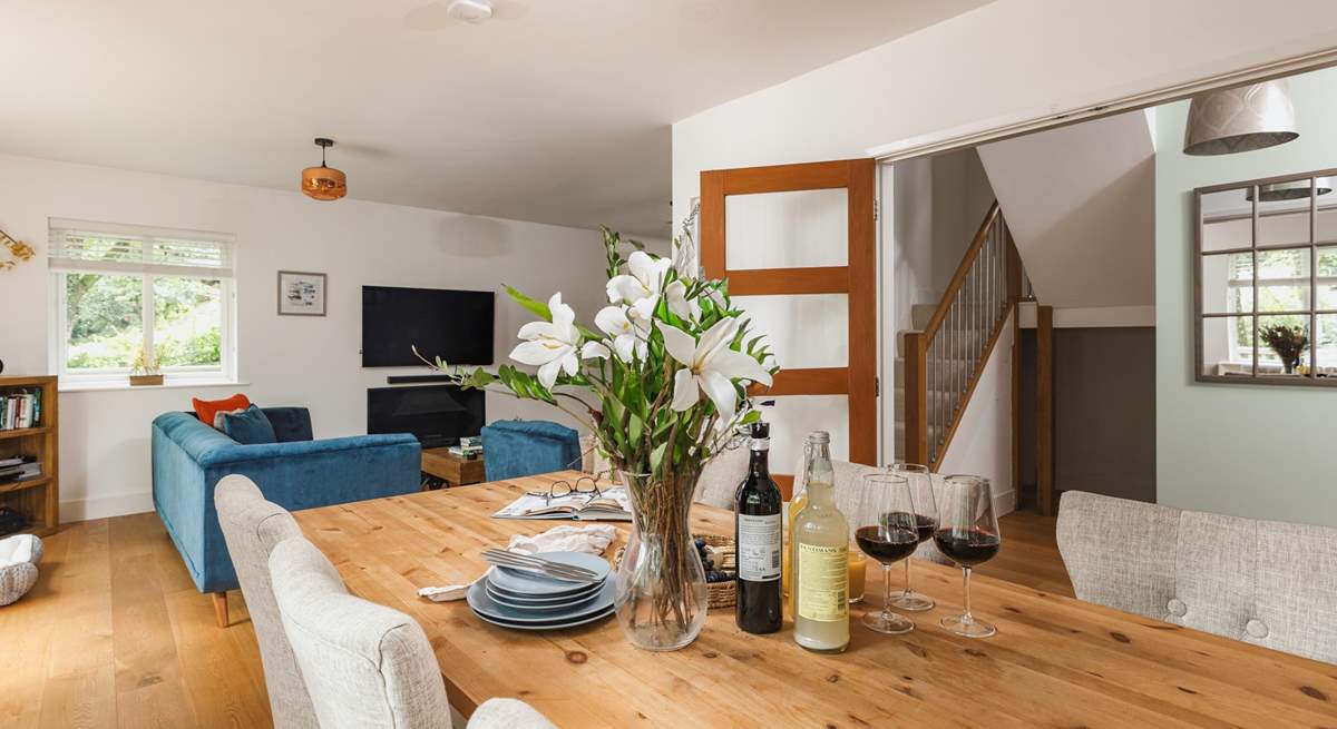 The open plan sitting/dining-room opens onto the wrap around terrace.